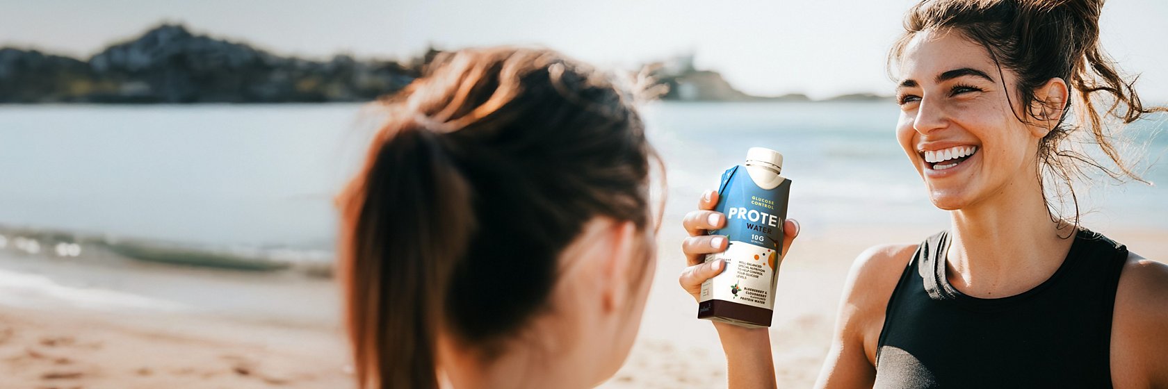Sports women with protein drink in Tetra Prisma Aseptic carton