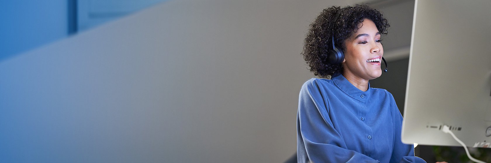 woman watching a webinar with headphones