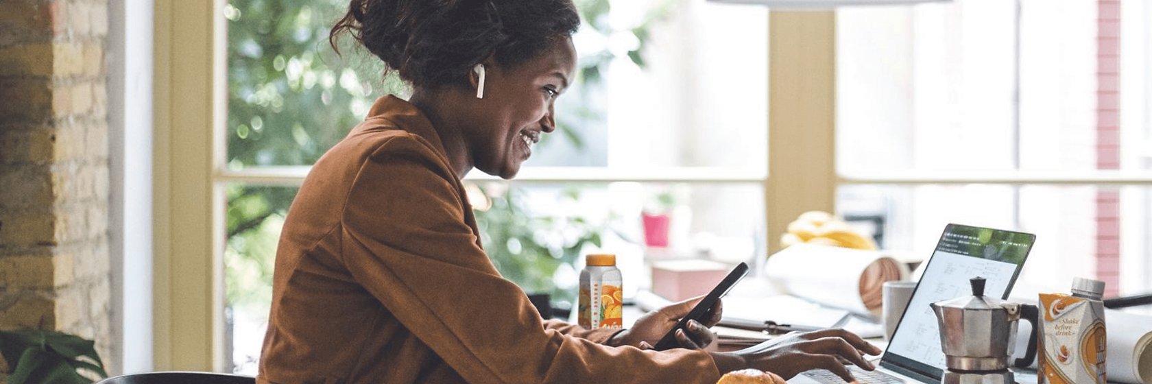 Woman with mobile sitting at desk